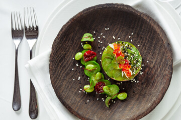 Salad of avokado, seafood, meat, vegetables and pumpkin seeds. Dietary, wholesome and tasty. Banquet festive dishes. Gourmet restaurant menu. White background.