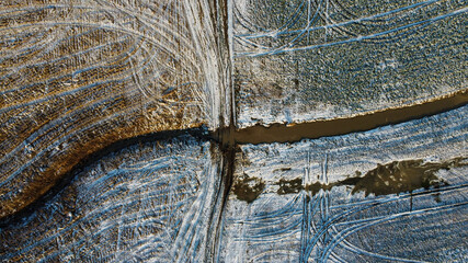 Drone shot of field covered in light snow