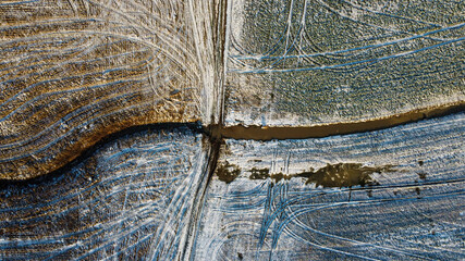 Drone shot of field covered in light snow
