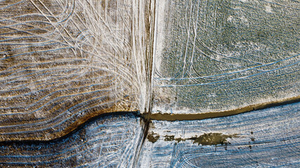 Drone shot of field covered in light snow