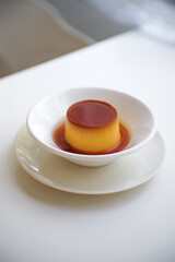Obraz na płótnie Canvas Pudding caramel custard in White ceramic bowl on table.