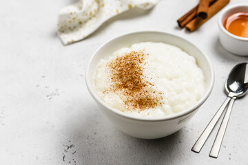 Cinnamon rice pudding in bowls. Space for text.