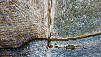 Drone shot of field covered in light snow