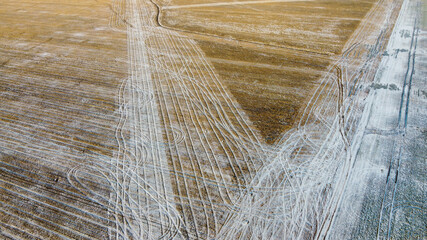 Drone shot of field covered in light snow