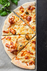 pizza seafood mussels, squid, shrimps prawn portion on the table cooking meal snack outdoor top view copy space for text food background