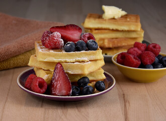 Homemade traditional belgian waffles with fresh fruits berries stock images. Fresh waffles with strawberries, raspberries and blueberries stock photo. Sweet breakfast with waffles and fruit images