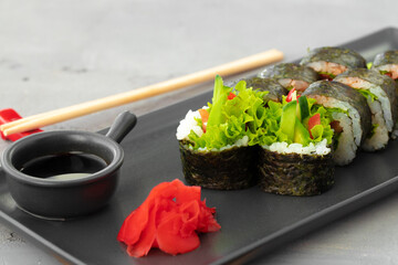 Vegeterian sushi roll with vegetables on stone plate