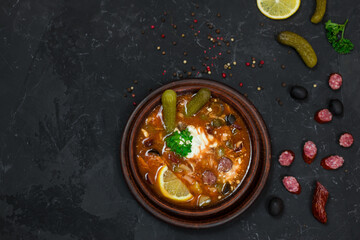 a national dish of Russian and Ukrainian cuisine. meat soup with pickles, olives, onions and lemon. with sour cream 