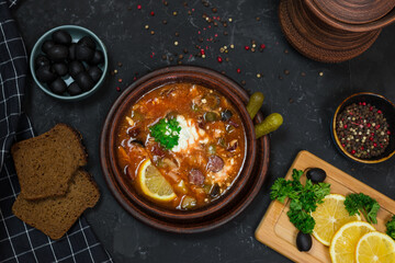 a national dish of Russian and Ukrainian cuisine. meat soup with pickles, olives, onions and lemon. with sour cream 