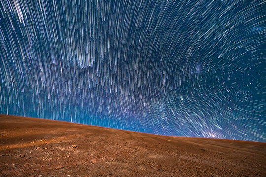An amazing view of the Milky Way rising in Atacama Desert night sky while the Moon sets. An awe view of the stars and all the artificial satellites space traffic as moving stars above the Desert field