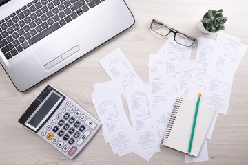 Naklejka na ściany i meble Bills and calculator with checks for goods and services.. calculator to calculate bills at the table in office. Calculation of costs.
