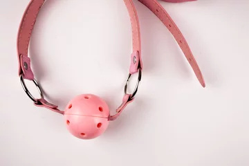 Pink Ball gag on pink background. Intimate toys. Sex abuse slavery © Матвей Саливанчук
