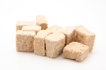 Brown cane sugar cubes isolated on white