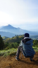 the photographer is photographing the mountain from the top of mount prau