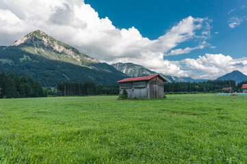 A barn in front of mountains