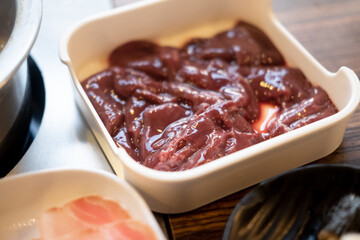 Fresh pork liver on white tray ingredients for shabu.