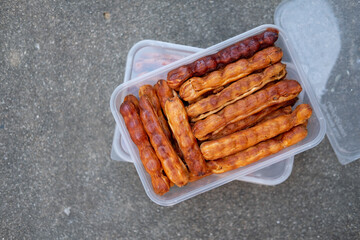 Tropical tamarind fruit without shell with visible seeds and inner pulp ready to eat in box