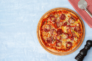 Delicious pizza with sausages on gray background