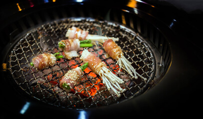 grill bacon with mushroom and asparagus on iron net barbecue