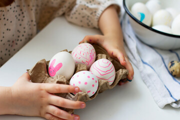Fototapeta na wymiar Little girl holding paints easter eggs. Easter concept. Preparing for Easter. Happy easter.