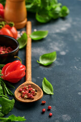 Vegetarian food, health or cooking concept. Wooden spoon and ingredients on old background.