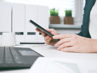 young woman typing on smartphone. Home office, online business marketing or learning concept. Online shopping, booking and banking background with copy space. tax return