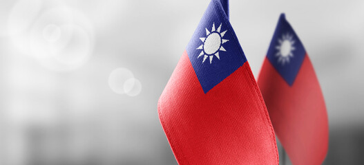 Small national flags of the Taiwan on a light blurry background