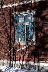 Abandoned old red house with white windows