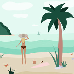 Girl on the beach looks at the horizon. Crab and palm tree