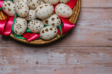 Colorful Easter Eggs in basket banner.Above view with copy space for text.Happy Easter decoration background,hand painted decorated eggs.Spring festive symbols.Holiday Still life photo.DIY product.
