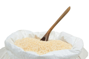 a wooden spoon sticks out of a pile of rice in a white bag close up on a white background