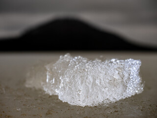 Shining sharp ice piece from broken ice floe. Spring warm days begun destruction of continuous ice cover