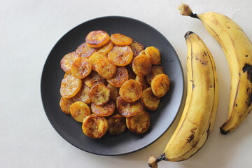 Caramelised plantain slices. A traditional tea time snack from Kerala.Cut ripe plantain into slices and toast it in a pan adding ghee n some brown sugar. © Trending Now