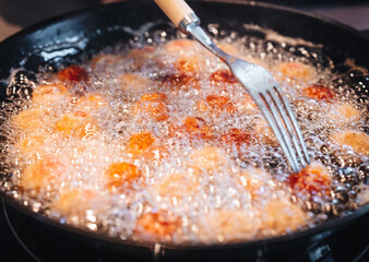 Frying home made italian traditional meatballs