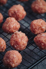 Raw home made Italian traditional meatballs