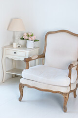 a white antique chair by the window. Beautiful Modern white room interior design