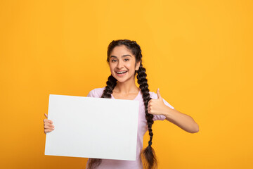 Indian female holding blank white advertising billboard showing thumbs up