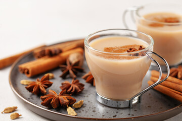 Masala tea in a glass cup with cardamom, star anise and cinnamon. Antiviral drink for immunity.
