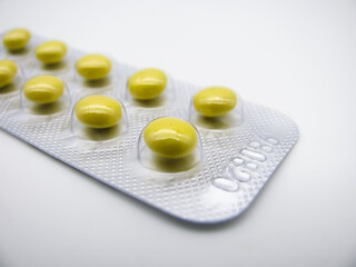 Valerian tablets in a yellow shell in a blister pack. A light sedative and hypnotic. The root of Valerian. The plant.