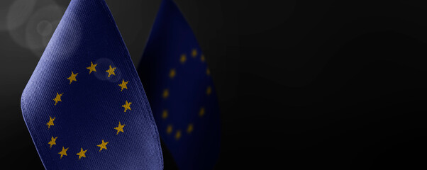 Small national flags of the European Union on a dark background