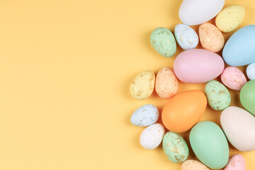 Naklejka na ściany i meble Easter yellow background with colorful eggs.
