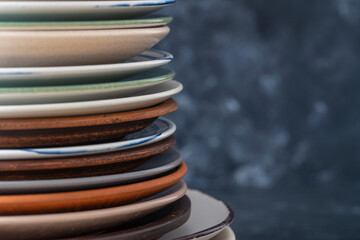 Many empty plate on black background, close up