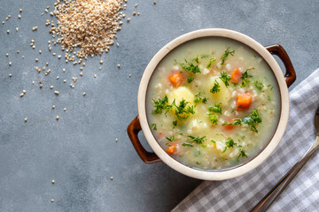 Krupnik, polish barley soup with vegetables in a bowl