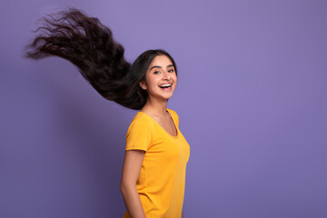 Indian woman posing with long flying hair at studio