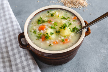 Krupnik, polish barley soup with vegetables in a bowl