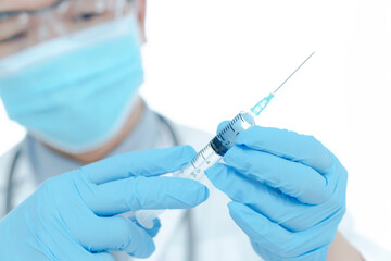 vaccines fight against virus, doctor or scientist in laboratory holding a syringe with liquid vaccines.