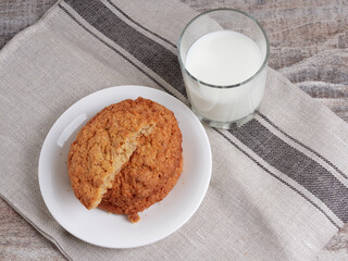 Homemade shortbread kamut cookies with glass of milk on light background