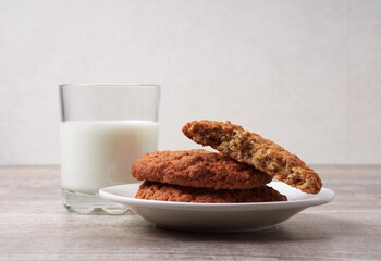 Homemade shortbread kamut cookies with glass of milk on light background
