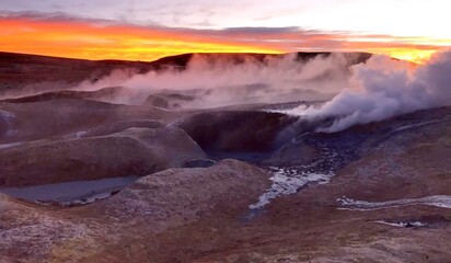 Surreal alien landscape of Geothermal valley Sol de Manana, Rising Sun steaming geyser field high up in massive crater in Bolivian Altiplano plateau, Bolivia