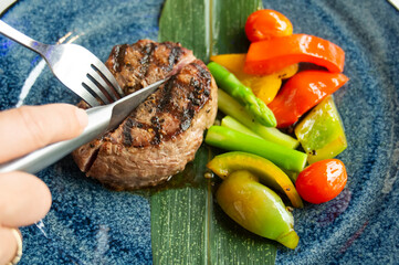 Cut or slice the medium-roasted steak on a plate. steak fillet